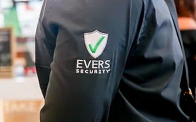 An Evers Security officer on duty, wearing the Evers Security emblem